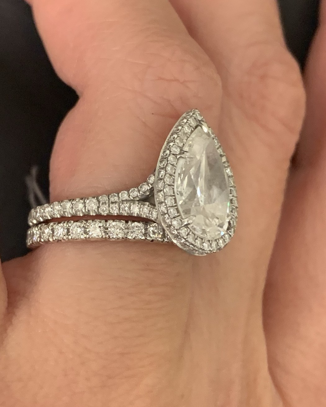Profile view of the pear halo ring stacked with its matched band, showing how the two sit together