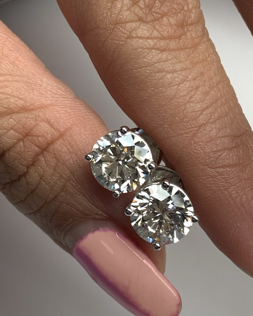 Second view of the matched round brilliant diamond studs showing the posts and backs