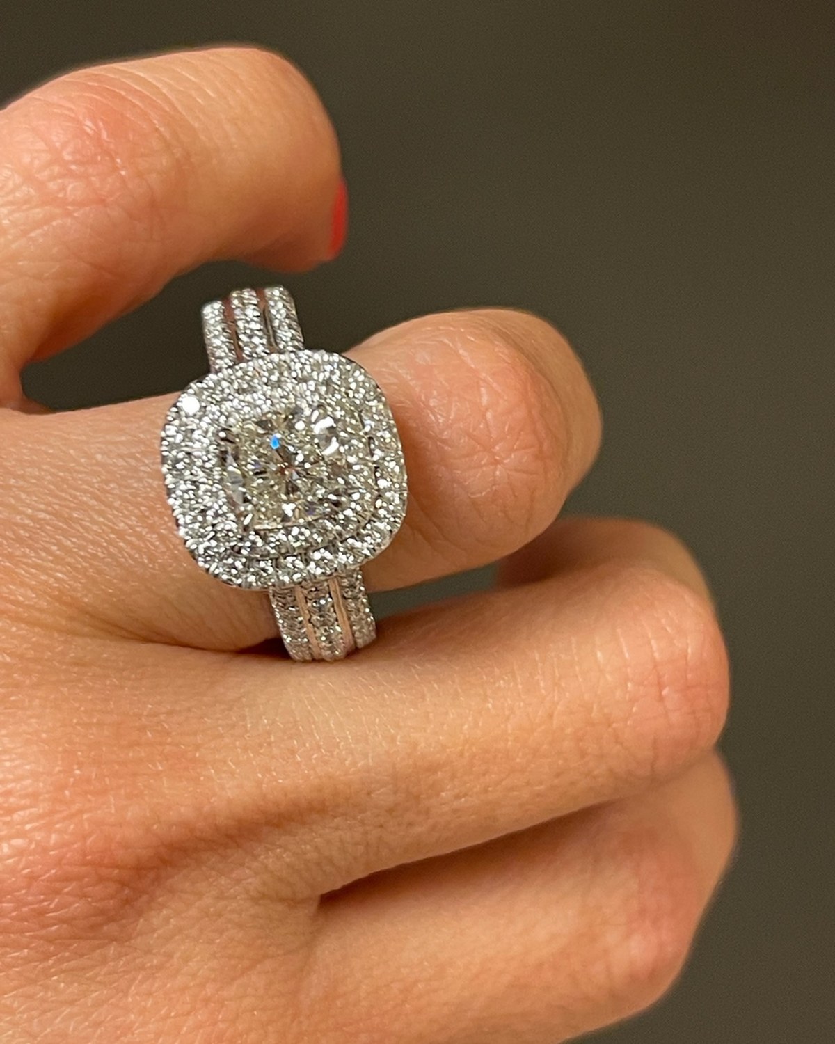 Face-up macro of a cushion-cut diamond inside a double diamond halo