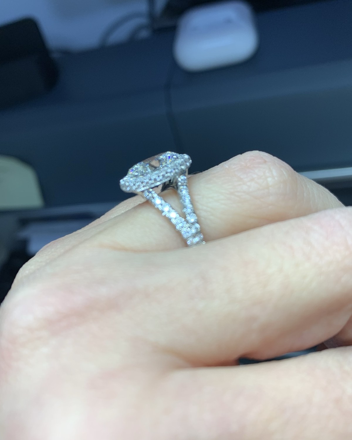 Profile view of the cushion halo split-shank ring on the hand, showing the height of the head